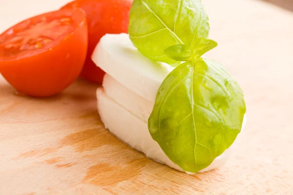 Tomate y Mozzarella en la tabla de cortar —  Fotos de Stock
