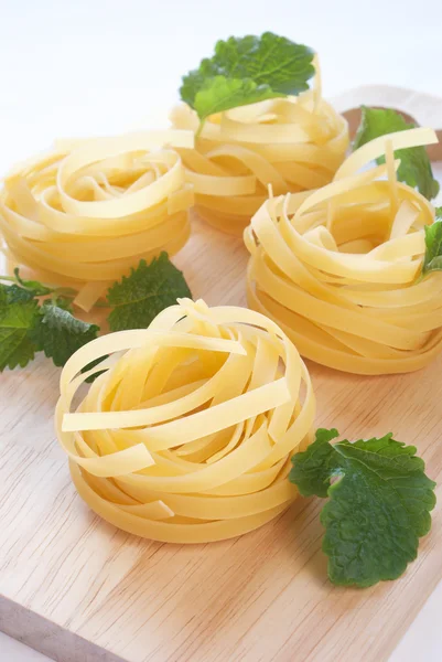 Raw fettuccine on the cutting board Stock Picture
