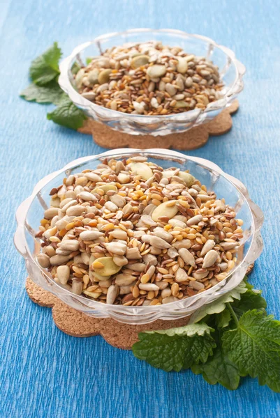 Seeds in glass bowl with herbs Stock Image