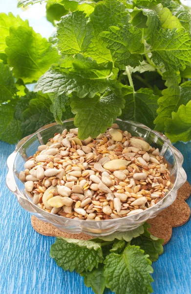 Seeds in bowl with herbs Stock Photo
