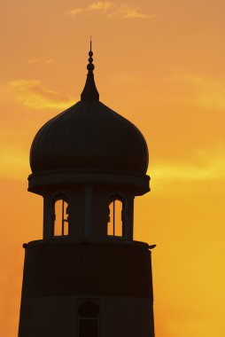 Silhouette of a mosque dome during a beautiful sunset clipart