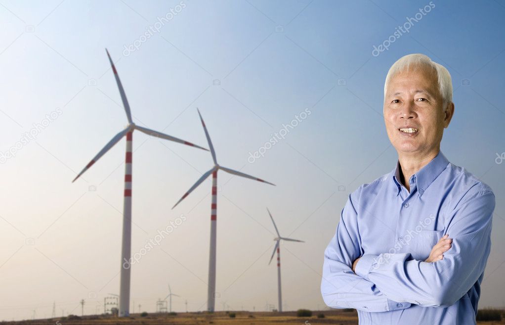 Asian senior with windmill on the background renewable energy concept photo