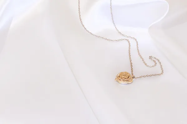 Gold pendant on white background — Stock Photo, Image