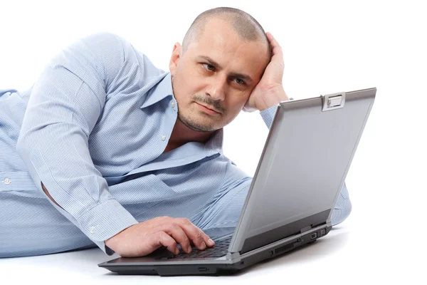 Relaxed businessman at his laptop Stock Photo