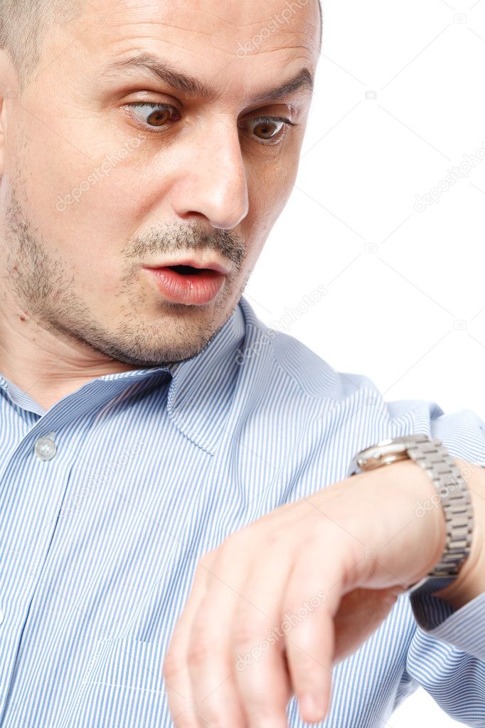 Late businessman looking at watch