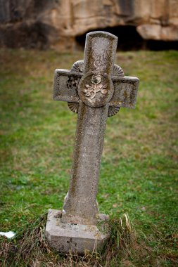 Ancient stone cross near the Corbii De Piatra monastery in Romania clipart