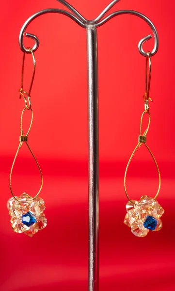 Beautiful Handmade Earrings Metal Holder Red Velvet Background — Stock Photo, Image