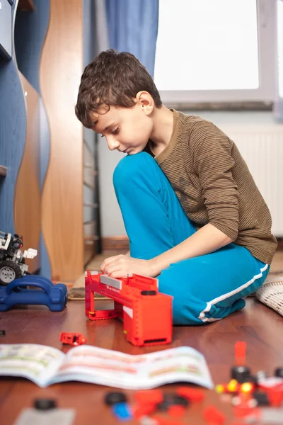 Boy playing with toys — Stock Photo, Image