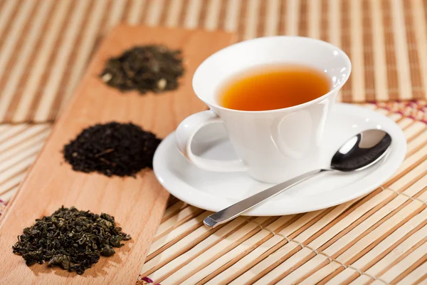 stock image Cup of tea and dried tea leaves