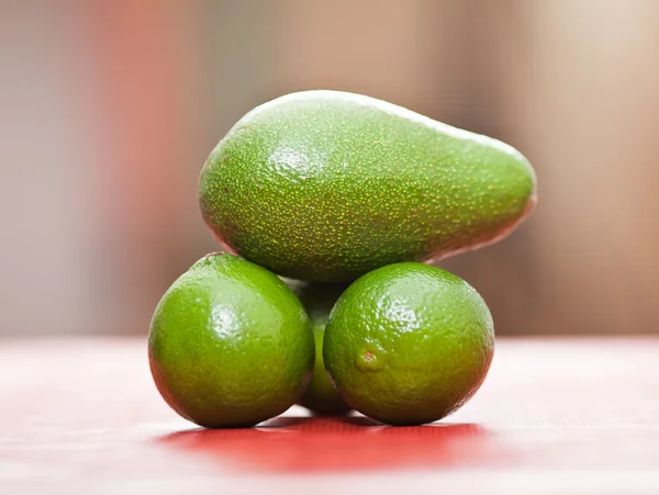Limes and avocado — Stock Photo, Image