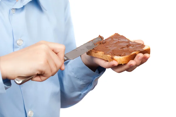 Дитина розпускає арахісове масло або шоколад на хлібі — стокове фото