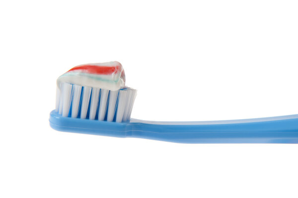 Closeup of Toothbrush and Toothpaste Over White