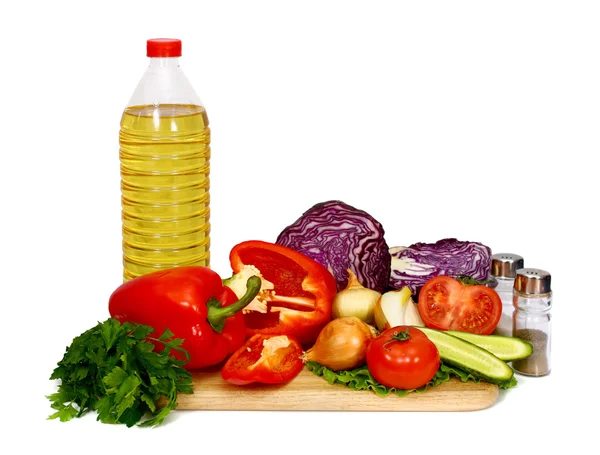 Sunflower seed oil and vegetables for preparation of salad — Stock Photo, Image