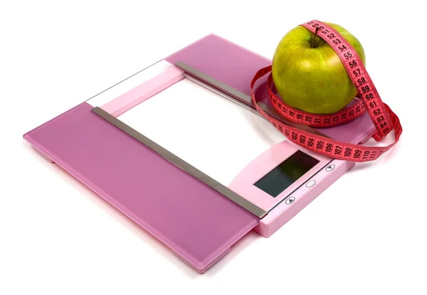 Floor scales measuring ribbon and green apple — Stock Photo, Image