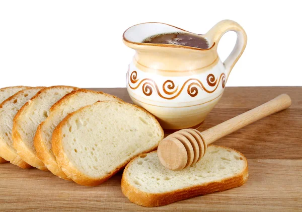 Mel em um jarro e pão a bordo — Fotografia de Stock