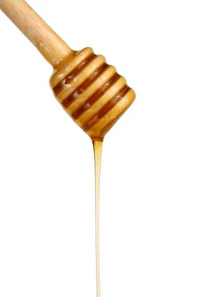 Honig fließt von einem Holzstab herab — Stockfoto