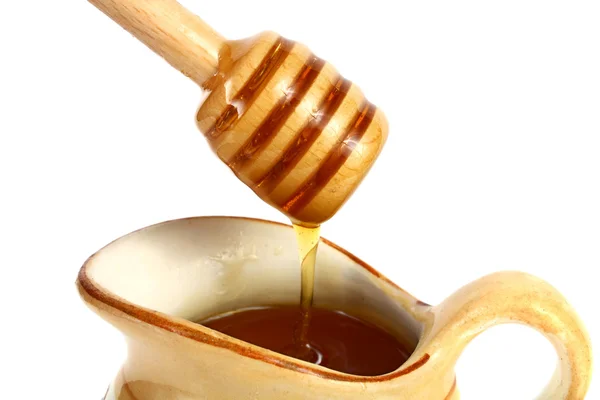 Honey flowing down from a wooden stick — Stock Photo, Image