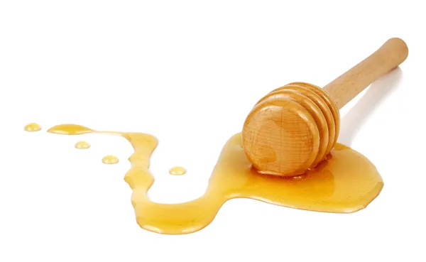 Honey flowing down from a wooden stick — Stock Photo, Image