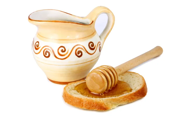 Honing in een kruik en brood — Stockfoto