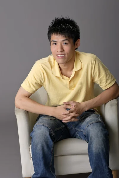 Young man sit on chair — Stock Photo, Image