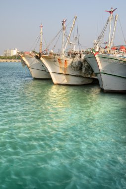 Fishing boats in harbor clipart