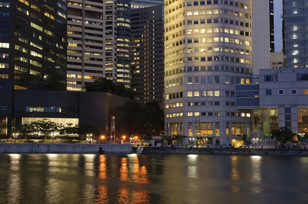 stock image Colorful city night with business building exterior with river.