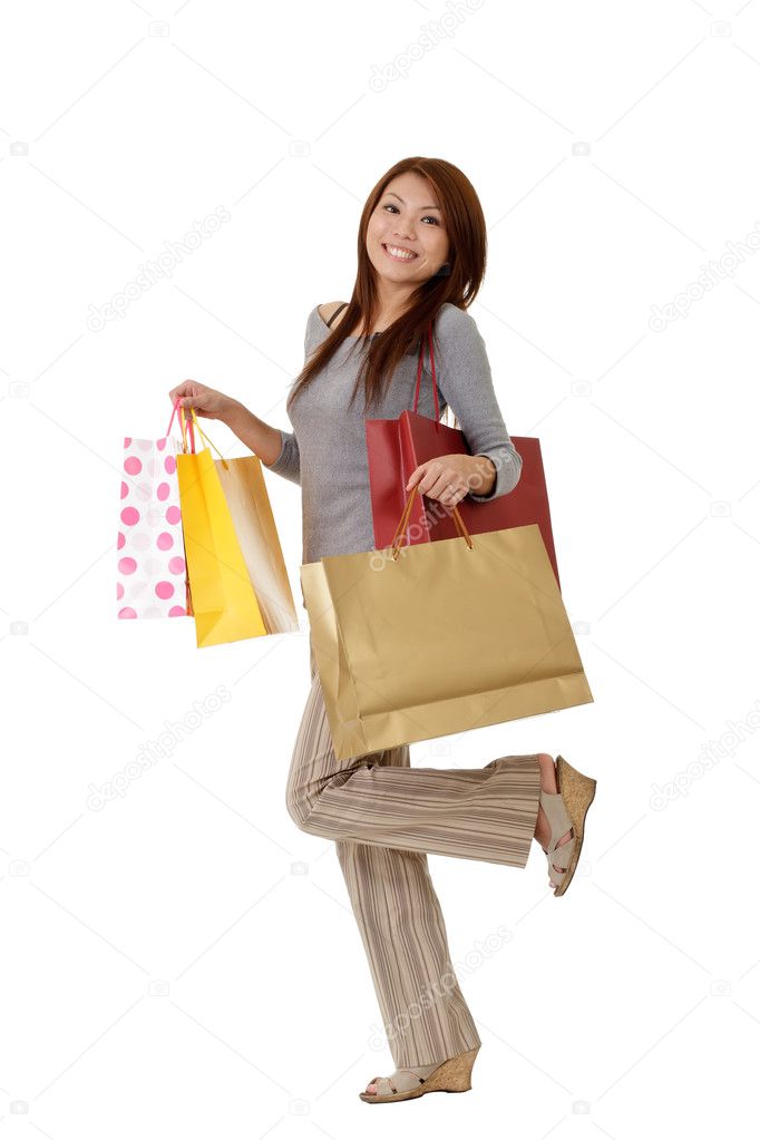 Shopping woman with bags on hand with glade expression on face.