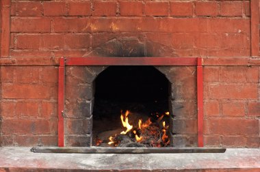 Chinese temple of fire burning in the brick stove. clipart