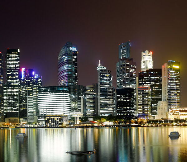 Night scene of modern city with buildings and river in Singapore, Asia.
