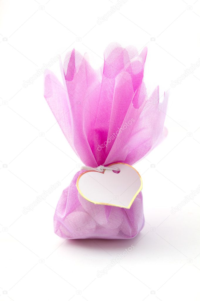 Wedding concept : pink bad of dragees isolated on white
