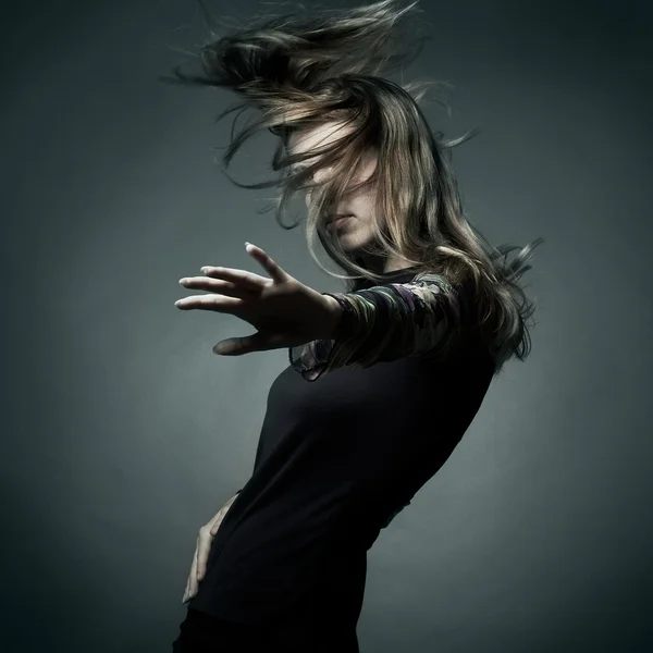 Fashion portrait of the beautiful woman with flying hair — Stock Photo, Image