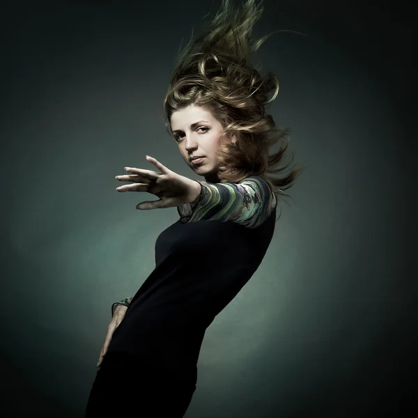 Fashion portrait of the beautiful woman with flying hair — Stock Photo, Image