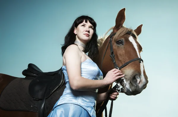 Beautiful young woman with a brown horse — Stock Photo, Image
