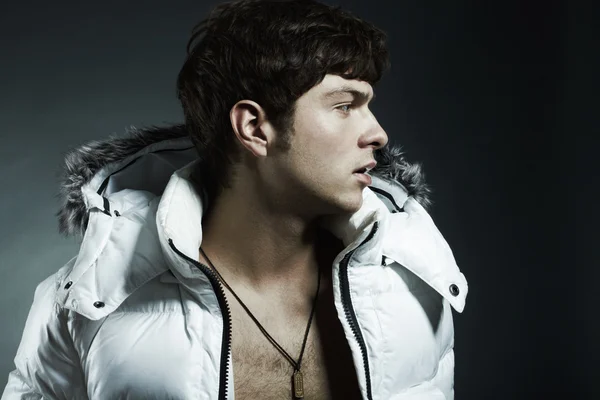Portrait of the young beautiful man in a white jacke — Stock Photo, Image