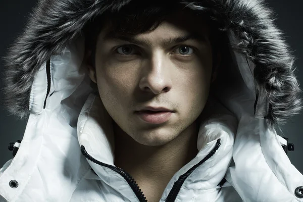Portrait of the young beautiful man in a white jacke — Stock Photo, Image