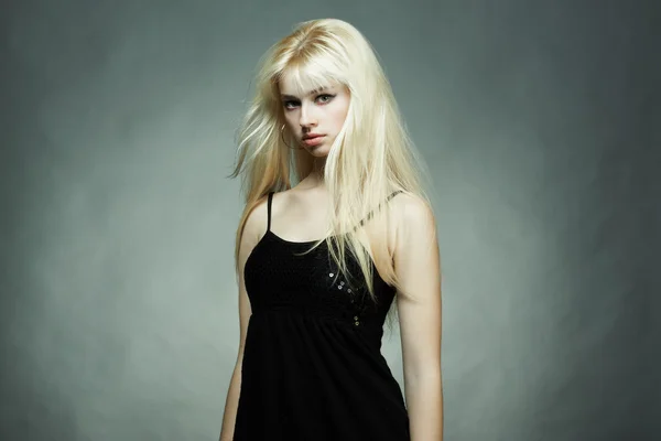 Portrait of the young blonde woman in a black dress Stock Photo