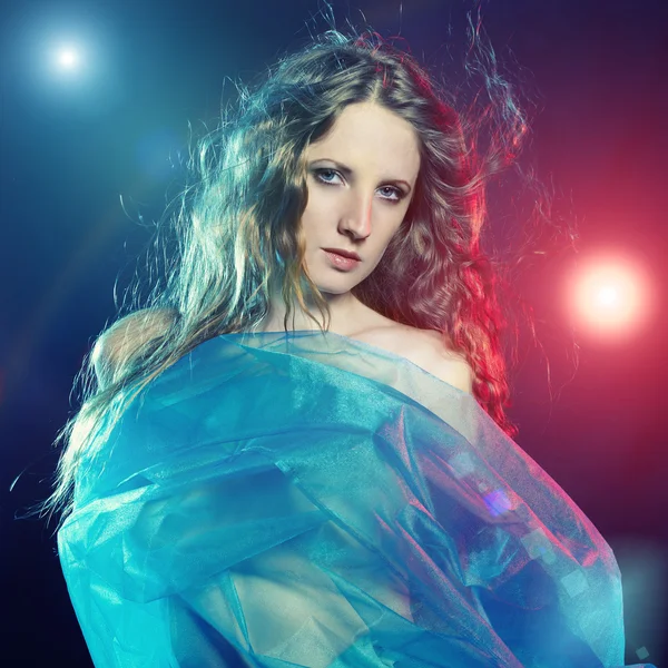Portrait of the young dancing woman against color flashes — Stock Photo, Image