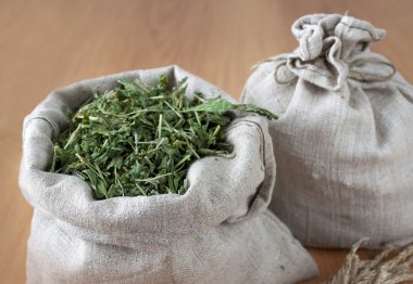 Dried herbs in linen bags clipart