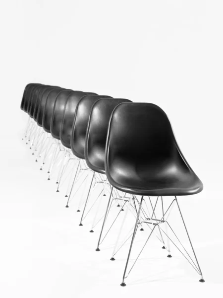 Black chairs in a row — Stock Photo, Image