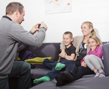 Father taking a photo of his family clipart