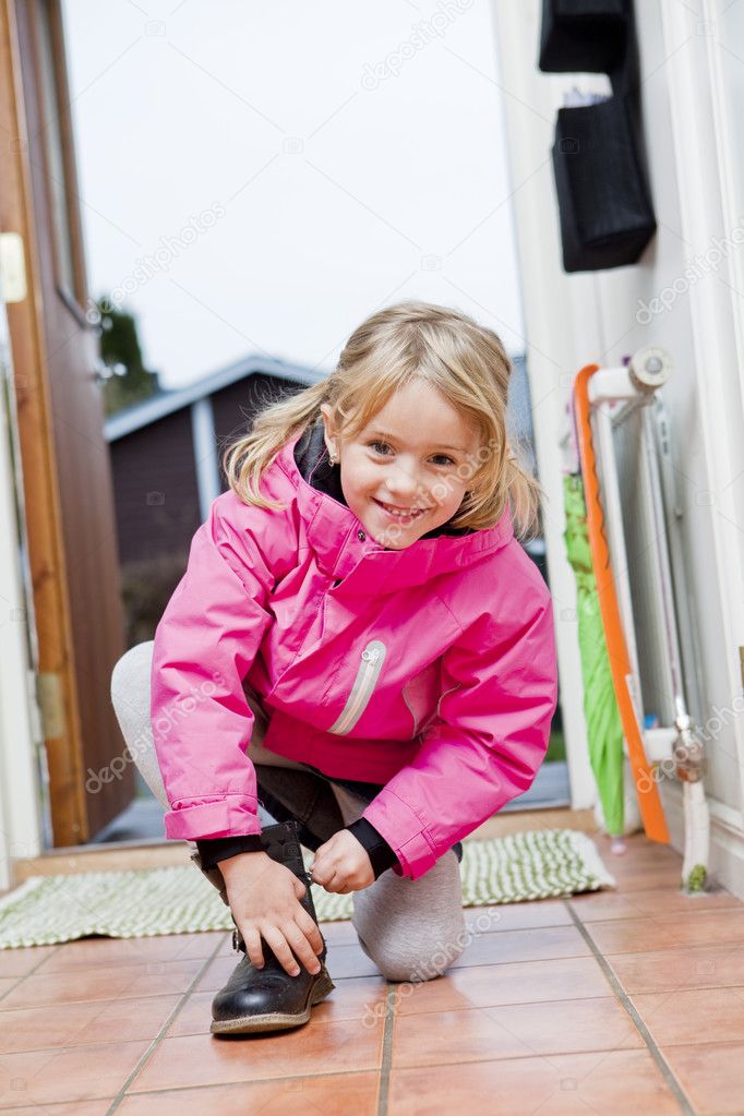 Little Girl tying her shoes Stock Photo by 4175712