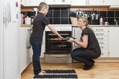 Mother and son in kitchen clipart