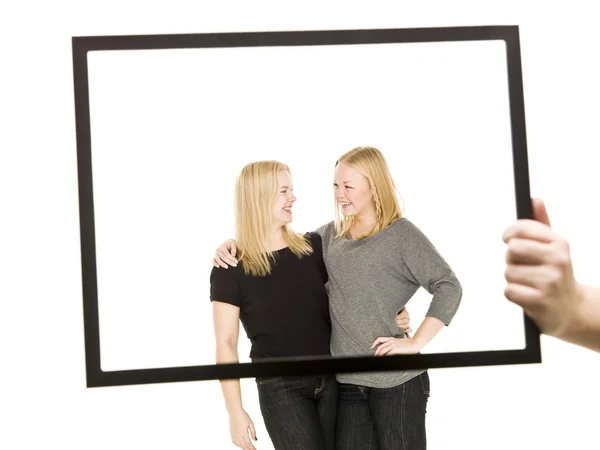 Two girls in a frame — Stock Photo, Image