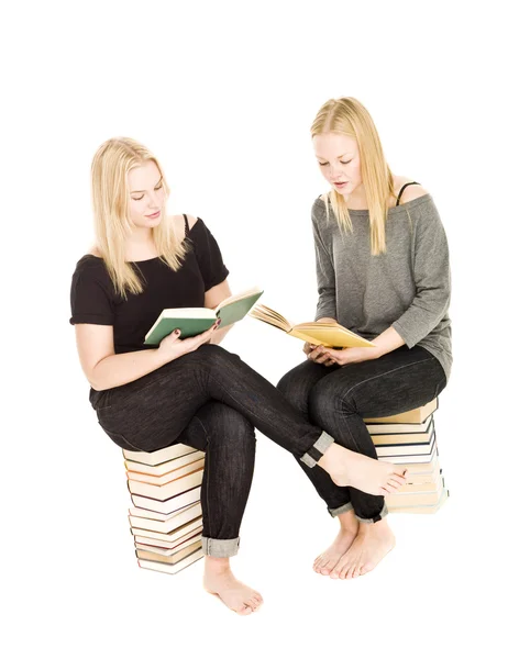 Chicas sentadas en montones de libros —  Fotos de Stock