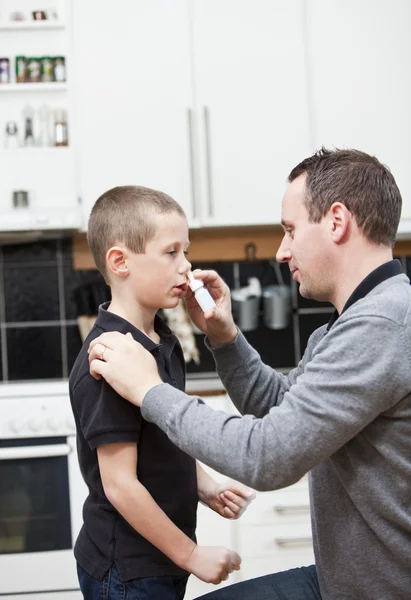 Father giving son Nose Drops — Stock Photo, Image