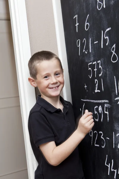 Young Boy in front of the blackboard — Stock Photo, Image