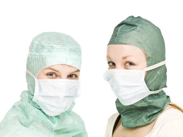 Chicas con máscaras quirúrgicas Imagen de archivo