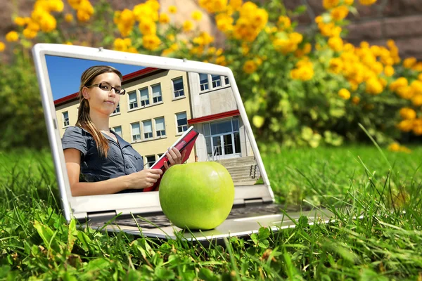 Laptop with female student on screen — Stock Photo, Image