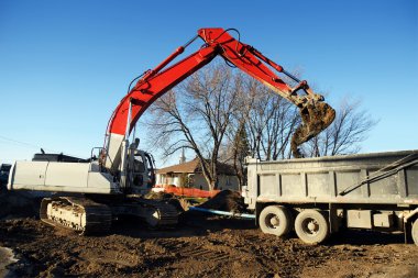 Mechanical digger and truck clipart