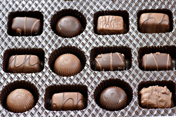 stock image Box of chocolates, dark and milk chocolate, round and squares, all yummy.